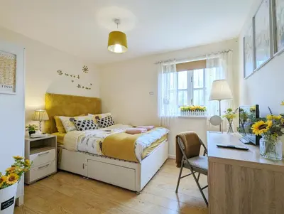 a small bedroom with a bed and a desk and a desk at City Centre Vintage Theme Guest Rooms in Liverpool