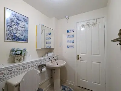 a white bathroom with a sink and a toilet at City Centre Vintage Theme Guest Rooms in Liverpool