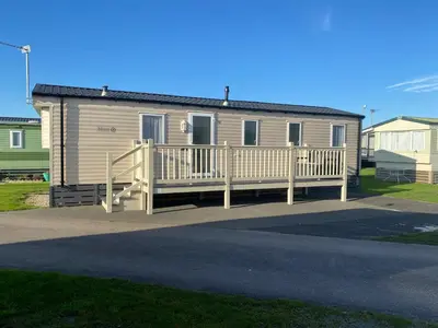 a mobile home with a porch and a deck at Ocean Edge Morecambe Sea view in Heysham