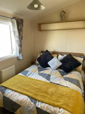 a bedroom with a bed with pillows on it at Ocean Edge Morecambe Sea view in Heysham
