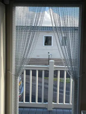 a window with a curtain on a balcony at Ocean Edge Morecambe Sea view in Heysham