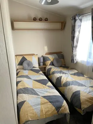 two beds in a small room with at Ocean Edge Morecambe Sea view in Heysham