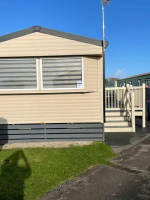 aige house with a porch and a white fence at Ocean Edge Morecambe Sea view in Heysham