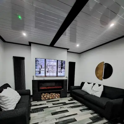 a living room with two couches and a fireplace at Family Holiday with Hot tub , Family groups only in Blackpool