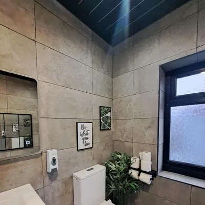 a bathroom with a toilet and a window at Family Holiday with Hot tub , Family groups only in Blackpool