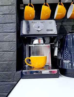a coffee maker with a yellow cup on a shelf at Family Holiday with Hot tub , Family groups only in Blackpool