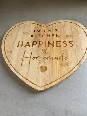 a wooden heart with the words in this kitchen happy happiness and homemade at Swift Retreat Caravan - Morecambe in Morecambe