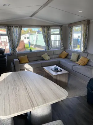 a living room with a couch and a table at Swift Retreat Caravan - Morecambe in Morecambe
