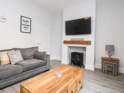 a living room with a couch and a fireplace at 37 Nutter Road in Cleveleys