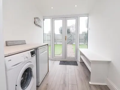 a white laundry room with a washer and dryer at 37 Nutter Road in Cleveleys
