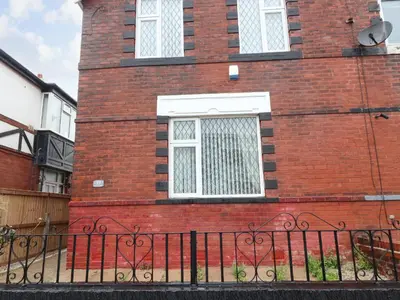 a brick building with a window and a black fence at 37 Nutter Road in Cleveleys