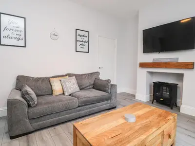a living room with a couch and a fireplace at 37 Nutter Road in Cleveleys