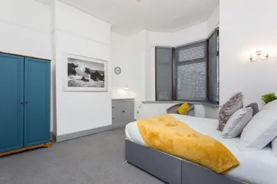 a bedroom with a bed and a blue door at The Station House in Preston