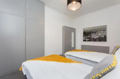 two beds in a room with white walls at The Station House in Preston
