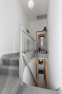a stairway with a white railing and a stair case at The Station House in Preston