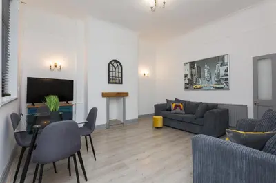 a living room with a couch and a table at The Station House in Preston
