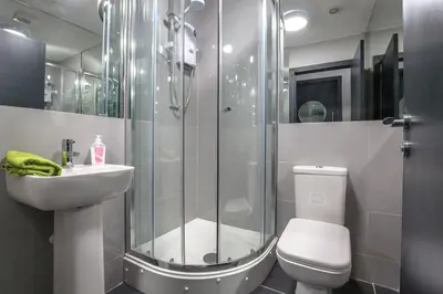 a bathroom with a shower and a toilet and a sink at Manhattan Suite - sleeps 24! Heart of Liverpool in Liverpool