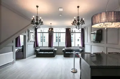 a large living room with chandeliers and a couch at Manhattan Suite - sleeps 24! Heart of Liverpool in Liverpool