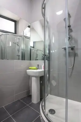 a bathroom with a shower and a sink and a shower at Manhattan Suite - sleeps 24! Heart of Liverpool in Liverpool