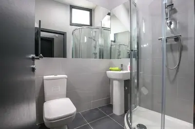 a bathroom with a shower and a toilet and a sink at Manhattan Suite - sleeps 24! Heart of Liverpool in Liverpool