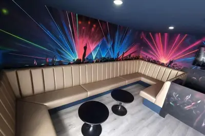 a room with a couch and a wall with lights at Penthouse Apartment, Sleeps 21 with terrace in Liverpool