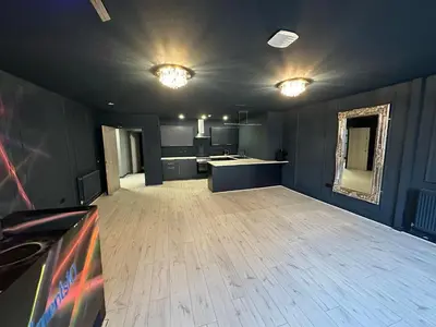 a large room with a kitchen and a living room at Unique city centre DJ apartment - sleeps 20 in Liverpool