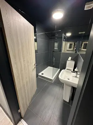 a bathroom with a sink and a toilet and a shower at Unique city centre DJ apartment - sleeps 20 in Liverpool