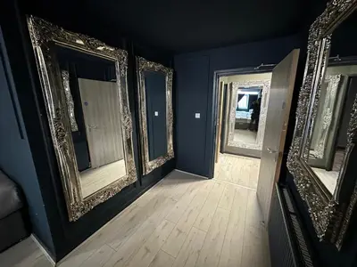 a room with three mirrors and a wooden floor at Unique city centre DJ apartment - sleeps 20 in Liverpool