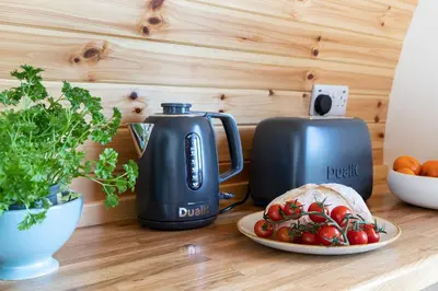 a tea kettle and a plate of food on a table at High Longlands in Cartmel