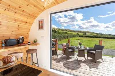 a kitchen and dining room with a large sliding glass door at Little Heaning in Cartmel