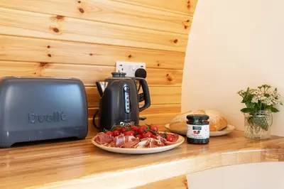 a toaster and a plate of food on a counter at Little Heaning in Cartmel