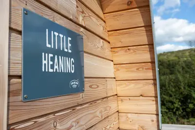 a sign on a building that reads little heating at Little Heaning in Cartmel