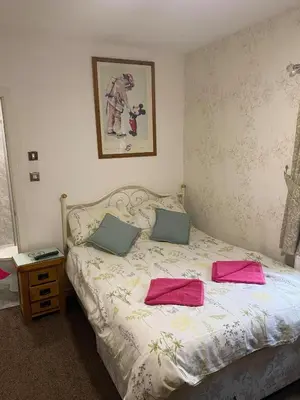 a bedroom with a bed with two pillows on it at JEANNE in Blackpool