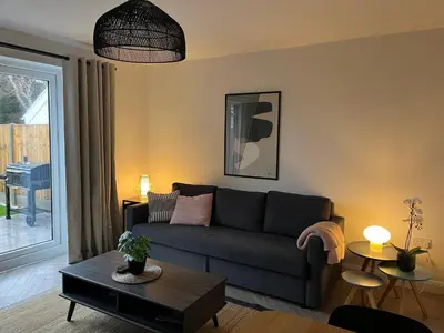 a living room with a couch and a table at Close to Lytham, Blackpool, Ribby Hall & BAE in Warton