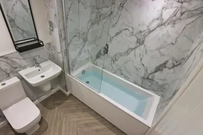 a bathroom with a tub and a toilet and a sink at Close to Lytham, Blackpool, Ribby Hall & BAE in Warton
