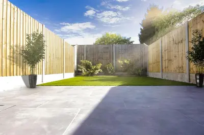 a backyard with a wooden fence and a lawn at Close to Lytham, Blackpool, Ribby Hall & BAE in Warton