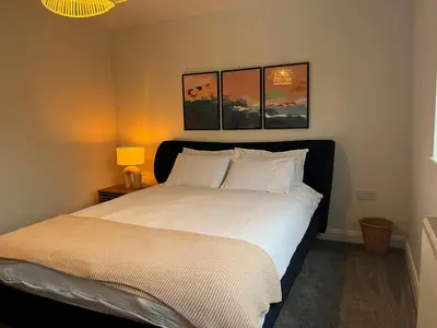 a bedroom with a bed with white sheets and pillows at Close to Lytham, Blackpool, Ribby Hall & BAE in Warton