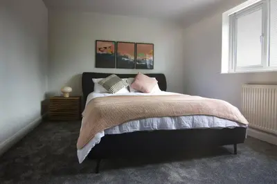 a bedroom with a large bed with pillows on it at Close to Lytham, Blackpool, Ribby Hall & BAE in Warton