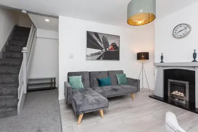 a living room with a couch and a fireplace at No 1 School House in Leyland