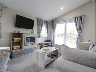 a living room with a couch and a tv at Fountain View in Carnforth