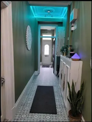 a hallway with a blue ceiling and a hallway with a hallway sidx sidx at By the Seaside in Blackpool