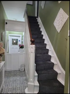 a staircase in a house with a stair case at By the Seaside in Blackpool