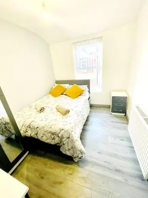 a bedroom with a bed with yellow pillows on it at Entrepreneur Stays - 8 Guest house in Liverpool
