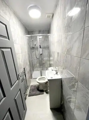 a bathroom with a shower and a toilet and a sink at Entrepreneur Stays - 8 Guest house in Liverpool