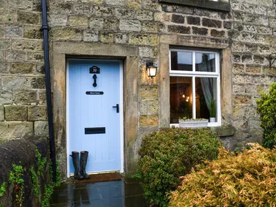 a house with a white door and a window at Shire Nooks in Hurst Green