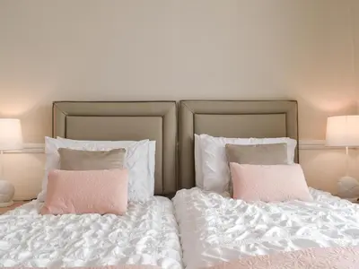 a bed with white sheets and pink pillows at Newcastle Lodges in Thornton