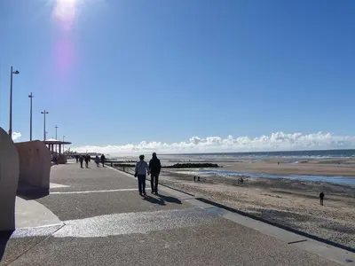 a group of people walking along the beach at Newcastle Lodges in Thornton