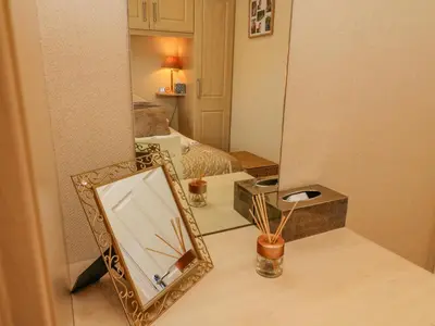 a mirror sitting on a counter next to a bedroom at Mallard Lodge in Carnforth