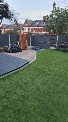 a backyard with green grass and a fence at Lovely unit elgin drive Coastal Bliss Your Seaside Retreat with City Excitement in Wallasey