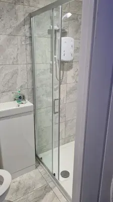 a bathroom with a shower with a toilet and a sink at Lovely unit elgin drive Coastal Bliss Your Seaside Retreat with City Excitement in Wallasey